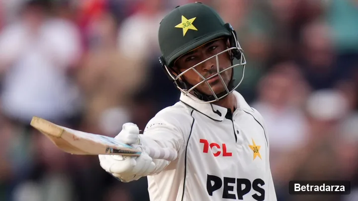 Pakistan debutant Razaullah in a green helmet and white kit raises his bat towards the Edgbaston crowd after reaching fifty